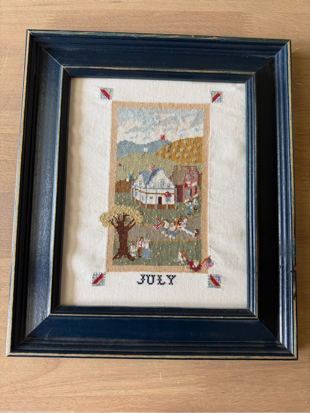 Vintage framed “July” embroidery with patriotic cottage motif